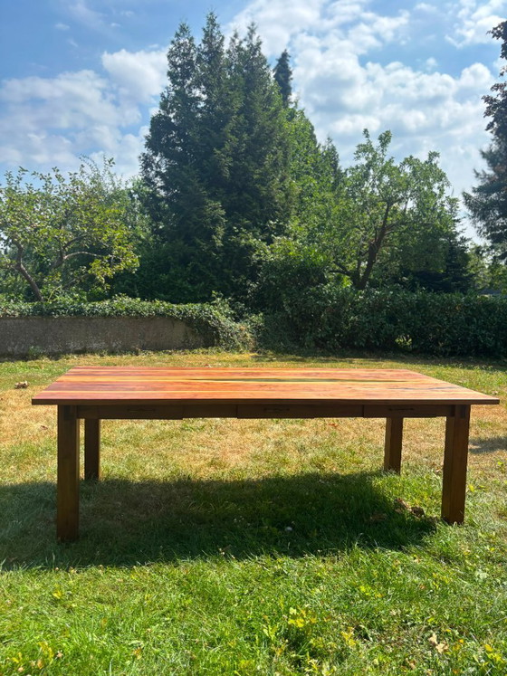 Image 1 of Dining table in American walnut and maple. Handcrafted solid wood extensions and drawers. Live edge for visual depth. Epoxy resi