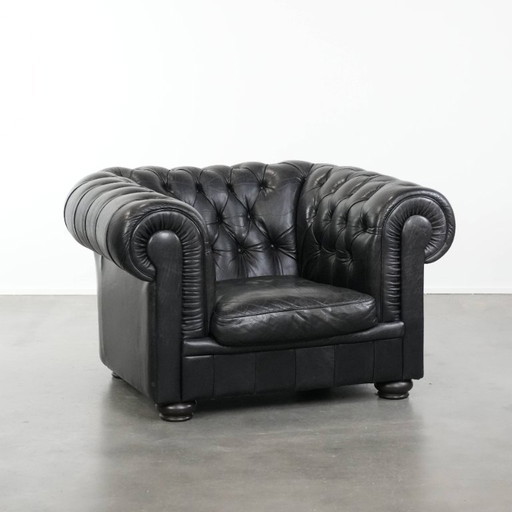 Black Chesterfield armchair made of cowhide