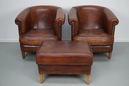 Vintage Nederlandse leren clubfauteuils in cognackleur, set van 2 met voetenbank