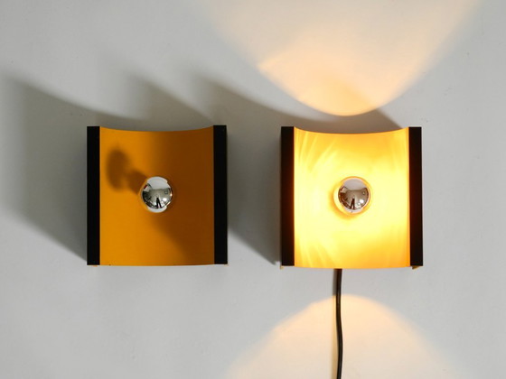 Image 1 of A rare pair of original 1960s Space Age metal wall lamps by Klaus Hempel for Kaiser Leuchten in yellow and black