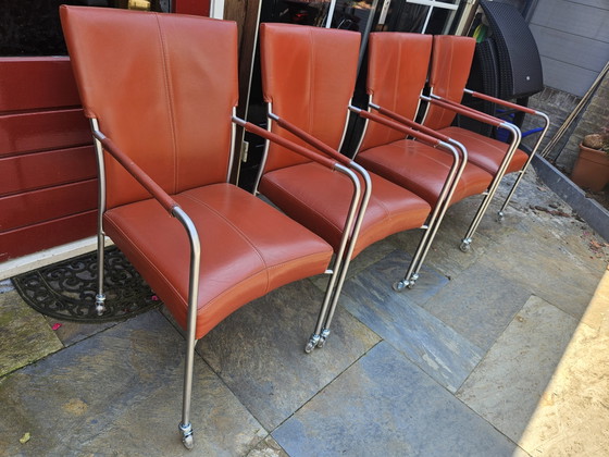 Image 1 of 4 red leather dining chairs on wheels, brand Bert Plantagie