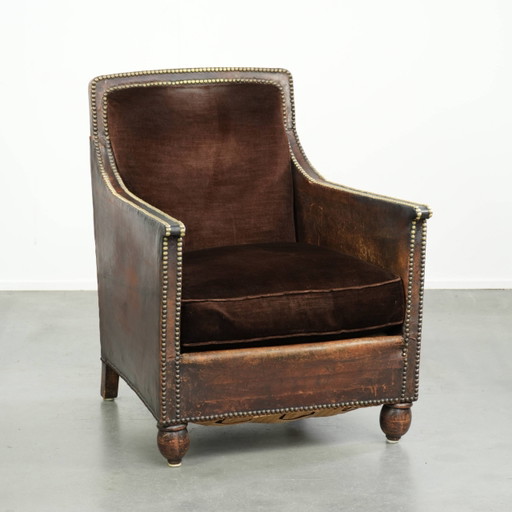 Characterful Art Deco design armchair finished in velvet and with decorative nails, with a unique look