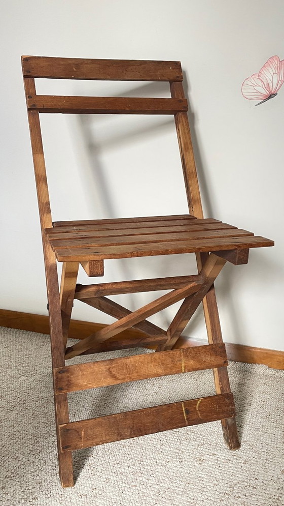 Image 1 of Antieke opklapbare houten stoel, een praktische en geometrische zitplaats. We zijn helemaal gecharmeerd van deze antieke stoel.