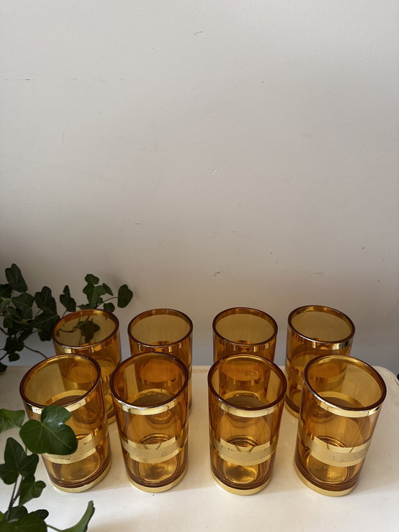 Image 1 of Set of 8 gold/amber colored glasses