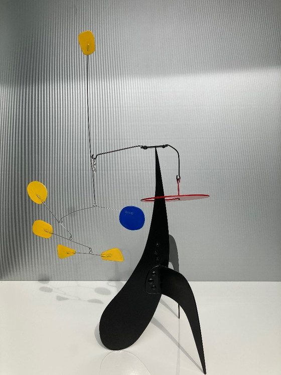 Image 1 of 5 Yellow And 1 Blue on a black stabile