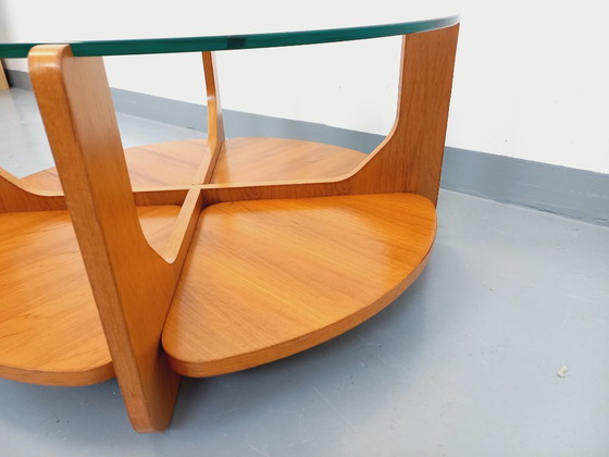 Image 1 of Vintage ronde salontafel met 2 bladen van Hugues Poignant, in teak en glas uit de jaren 60 en 70