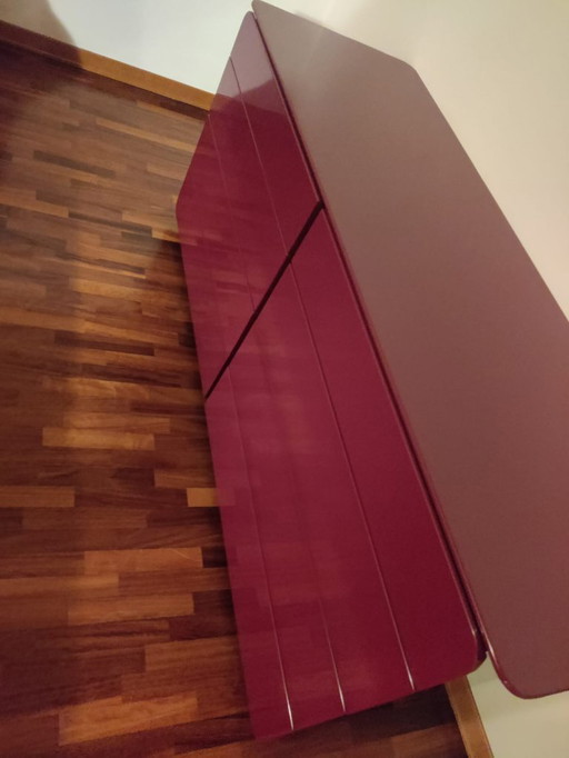 Burgundy red chest of drawers and two bedside tables