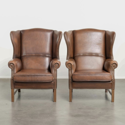 2x charming cowhide leather Armchairs in English style finished with decorative studs