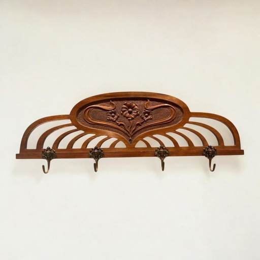 Art Nouveau coat rack with 4 sculpted brass hooks, floral carving and elaborate chasing as well as gold-plated accents