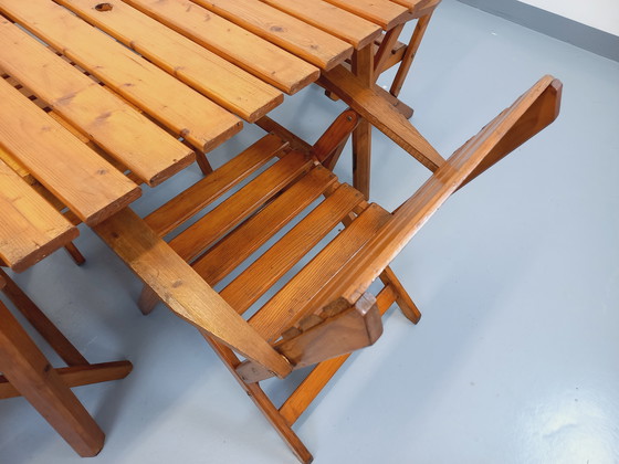 Image 1 of Vintage garden furniture consisting of a table with extensions and 4 wooden armchairs from the 60s