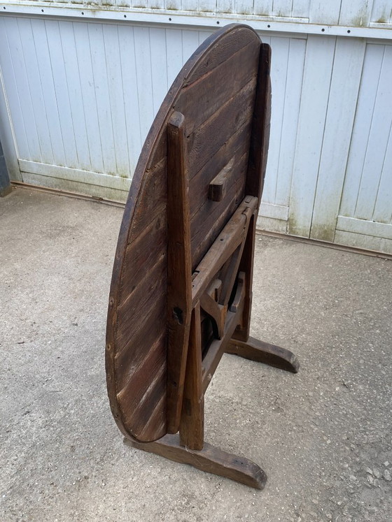 Image 1 of antique folding round winemaker's target table with tilting top