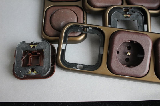 Image 1 of Large collection of vintage brown sockets and light switches with antique gold frames, 1960s/70s