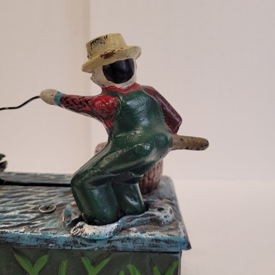 Image 1 of "Fisherman" piggy bank with fishing mechanism, cast iron, 1950s - USA.