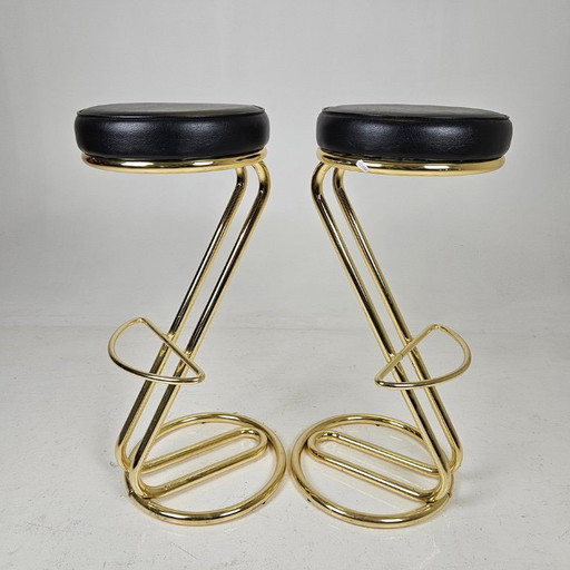 two bar stools, distinguished by their clean lines, high-quality craftsmanship, and timeless elegance.