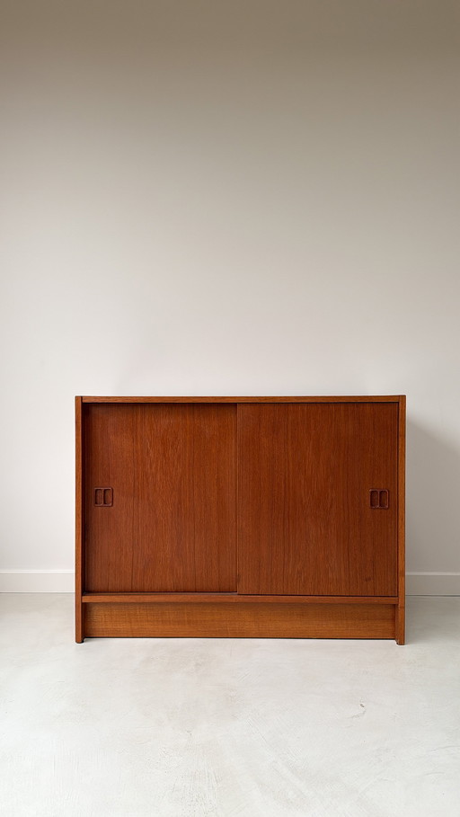 Vintage Danish wooden cabinet with sliding doors