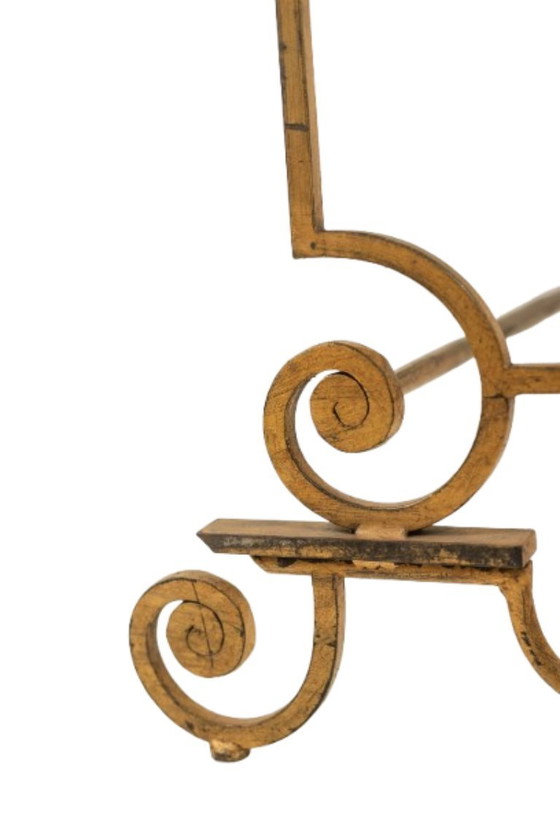 Image 1 of Table basse en fer forgé doré et plateau de verre églomisé. Années 1970