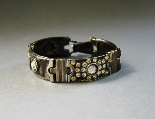 Bracelet by Luigi Briglia, silver-colored, set with clear, faceted stones and signed.