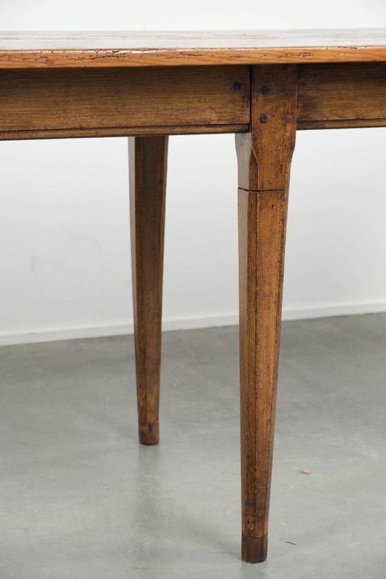 Image 1 of Large, relatively narrow antique French farmhouse dining table made of pine from the early 19th century with a beautiful patina.