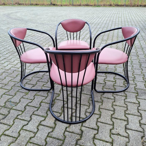 Image 1 of This is a set of four vintage 'Memphis' style chairs with a black metal frame and burgundy upholstery.