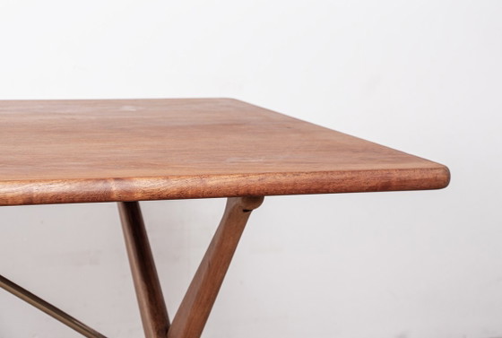 Image 1 of Deense eettafel van massief teak en beukenhout met messing, model AT 303, ontworpen door Hans Wegner voor Andreas Tuck in 1960.