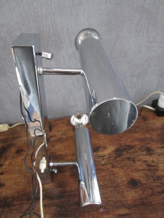 Image 1 of This chrome-colored space-age wall lamp is attributed to designer Gaetano Sciolari from the 1970s.