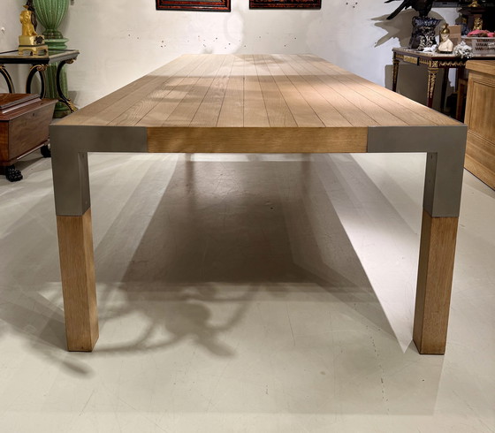 Image 1 of A large oak dining table, designed by Claire Bataille and Paul Ibens