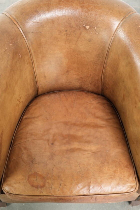 Image 1 of Vintage sheepskin club armchair with beautiful colors and finished with decorative nails.