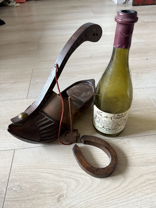 Decorative wooden wine bottle holder with a built-in ringing mechanism