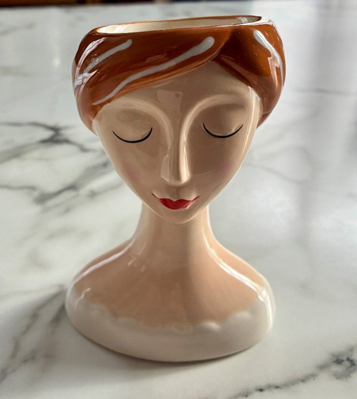 Small vase or flower pot with a woman's face