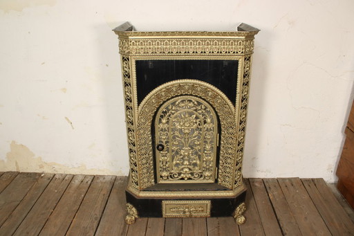 Antique cast iron stove • Vintage iron parlor heater with decoration