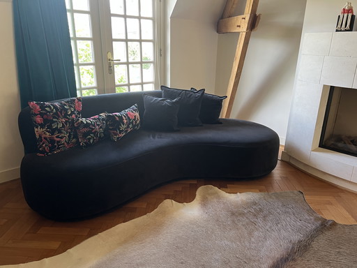 Black velour curved sofa