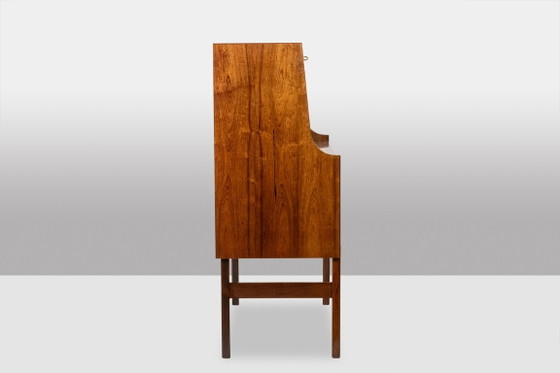 Image 1 of Commode van palissanderhout met 2 laden, die tevens als secretair dient. Jaren 70.