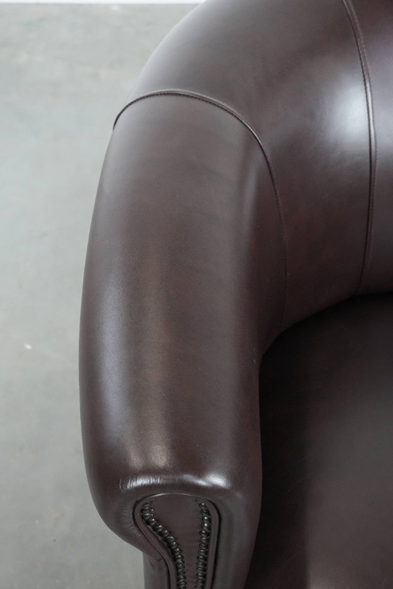 Image 1 of Cowhide club armchair, in very good condition, English style in a brown/dark purple color scheme