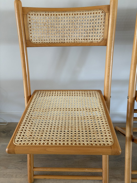 Image 1 of Twee vintage inklapbare houten met webbing stoelen 