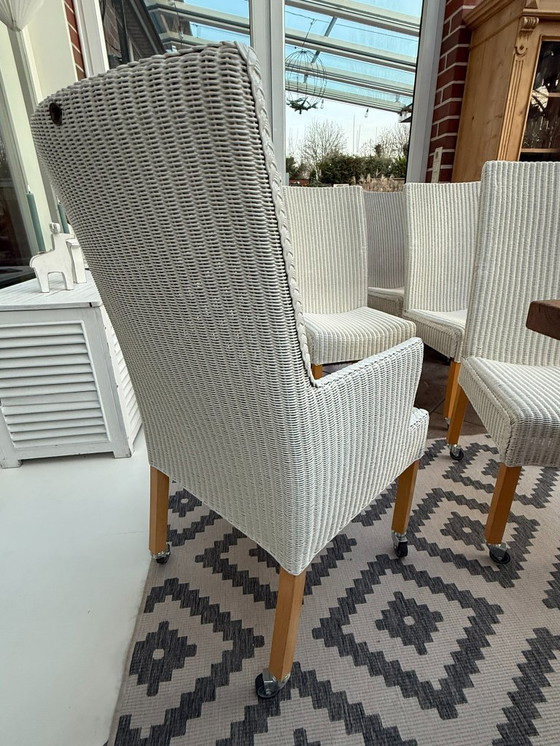 Image 1 of 8 originele Lloyd LOOM stoelen, eetkamerstoelen, ook in kleinere aantallen verkrijgbaar, houten frame, wit riet.