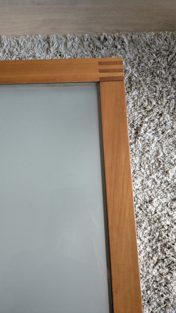 Image 1 of cherry wood red coffee table with sleek glass top from 1996