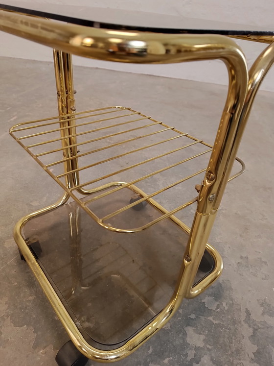 Image 1 of Vintage gold coloured and glass trolley side table 
