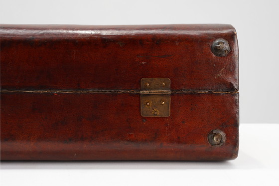 Image 1 of Vintage brown leather suitcase with copper details, China 1900s