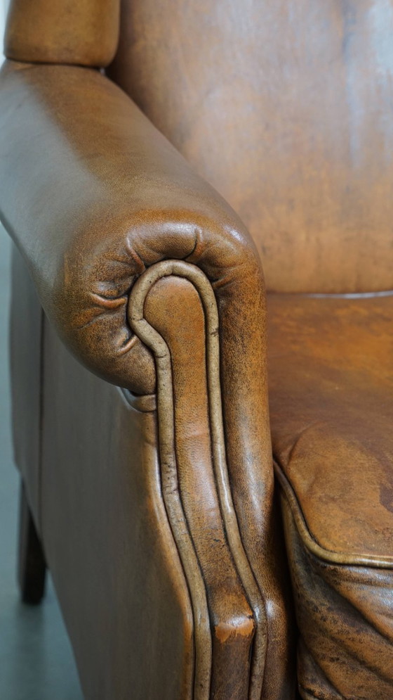 Image 1 of Karaktervolle vintage schapenleren oorfauteuil met een mooi patina