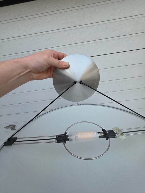 Image 1 of A striking design from 1996 by Luciano Balastrini for Luceplan, a large cutout of a sphere made of polycarbonate featuring a dia