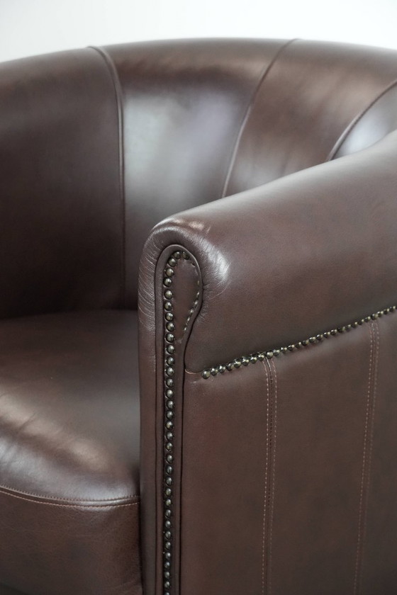 Image 1 of Cowhide club armchair, in very good condition, English style in a brown/dark purple color scheme