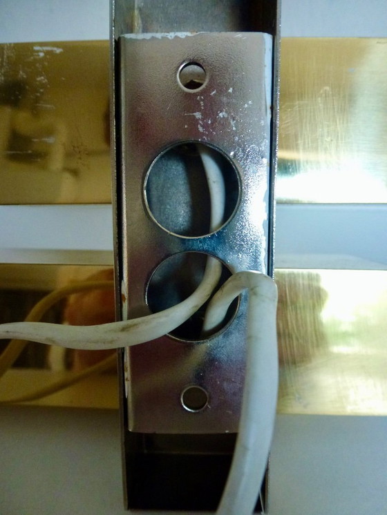 Image 1 of A brass wall lamp, in a minimalist, geometric style, from the middle of the last century.