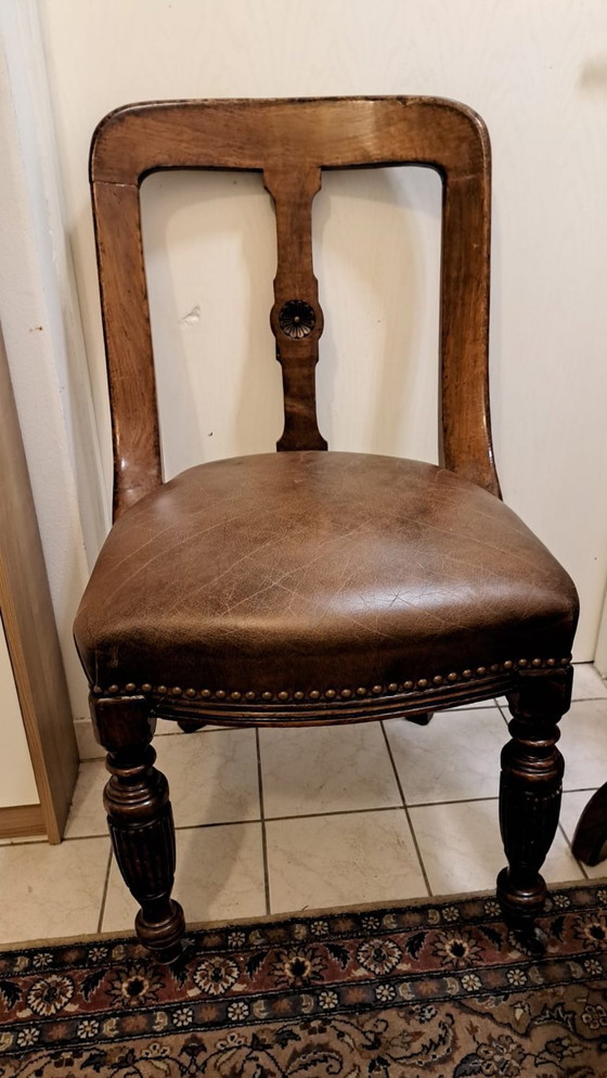 Image 1 of 4 antique wooden chairs with leather upholstery and decorative nails