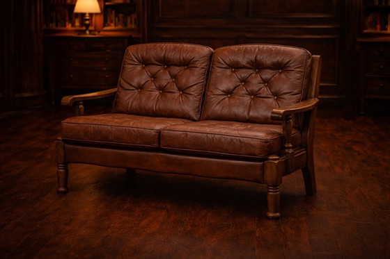 Image 1 of A vintage brown three-piece sofa set in leather with wooden armrests and turned legs, comprising a 1-seater, 2-seater and 3-seat