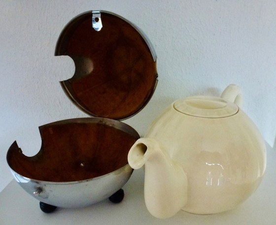 Image 1 of Ceramic Teapot with thermal Chrome casing which keeps the contents hot (or cold).