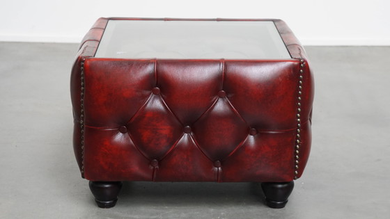 Image 1 of Beef leather chesterfield side/ coffee table in a red color with glass top