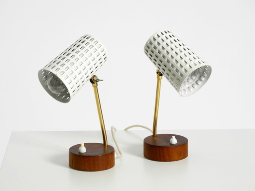 A pair of beautiful mid-century modern bedside lamps with perforated metal shades and teak wood bases
