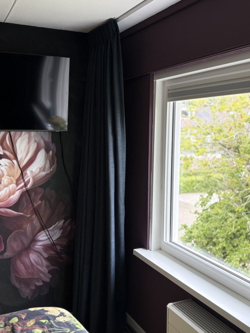 Floor-to-ceiling dark blue curtains