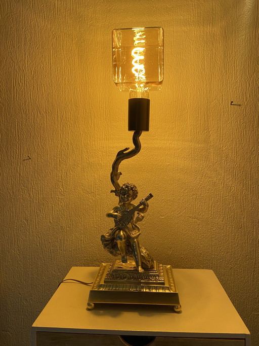 Bronze table lamp depicting a cherub playing the guitar