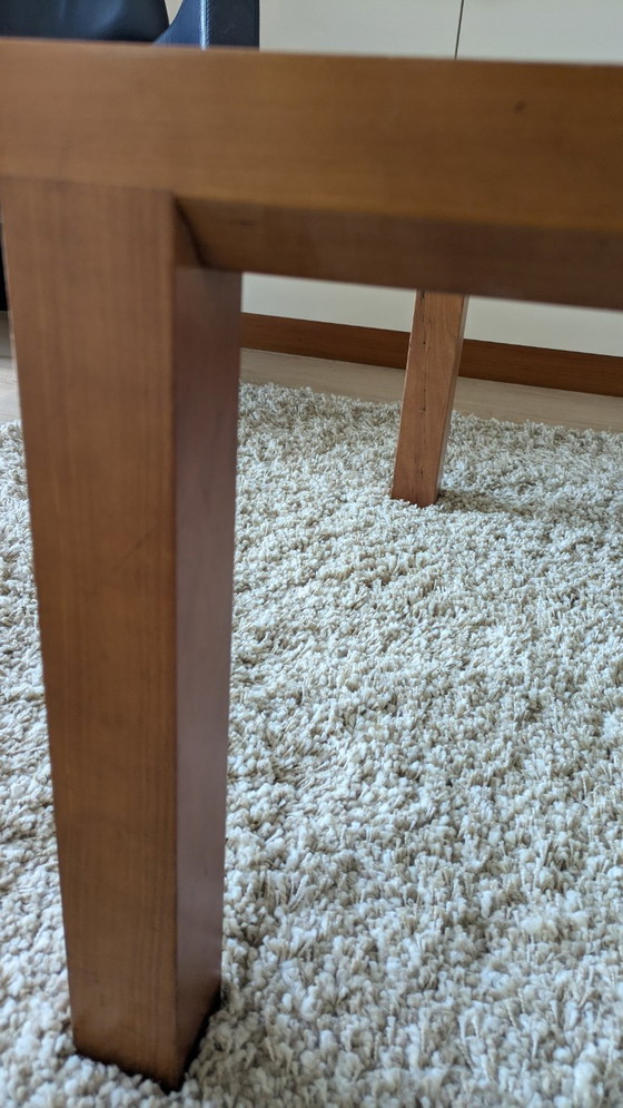 Image 1 of cherry wood red coffee table with sleek glass top from 1996